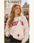 Model wearing the cream Honey Sling with embroidered Indiana University IU mark and gold hardware on campus