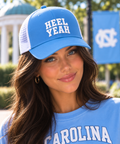 Model wearing the Carolina blue Honey Lid with white HEEL YEAH puff embroidery