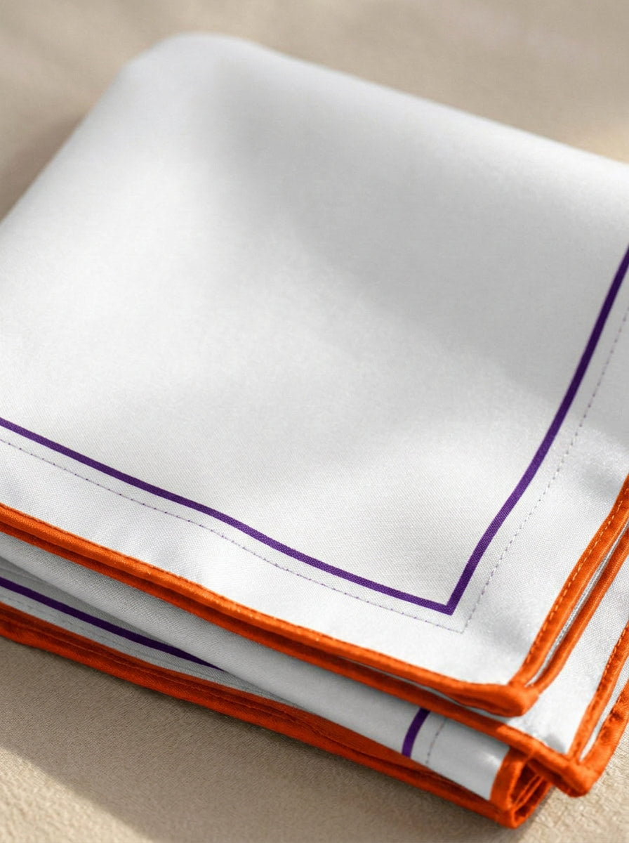 Folded corner detail of the Clemson Honey Pocket silk square