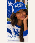Model wearing The Honey Lid: University of Kentucky, a blue and white Richardson 115 trucker cap with Bluegrass Baby embroidery