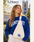 Model on the University of Kentucky campus wearing the cream b.Honey Honey Sling with embroidered blue UK mark