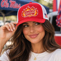 Woman in an Ole Miss tee wearing the b.Honey Honey Lid Smoke Show red and white Richardson 115 low-profile trucker hat