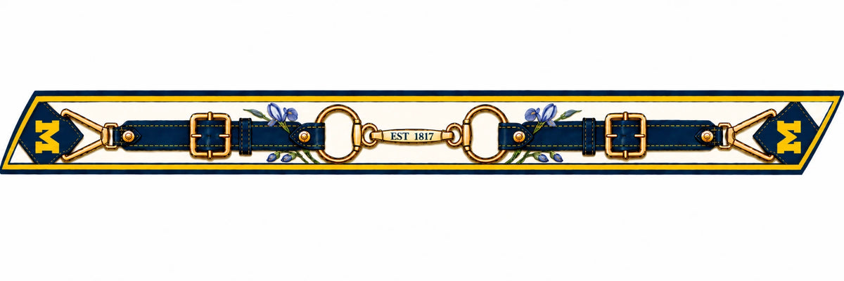 Honey Ribbon: University of Michigan flat artwork — cream ground, navy straps, gold buckles, EST 1817 bit and gold block M ends