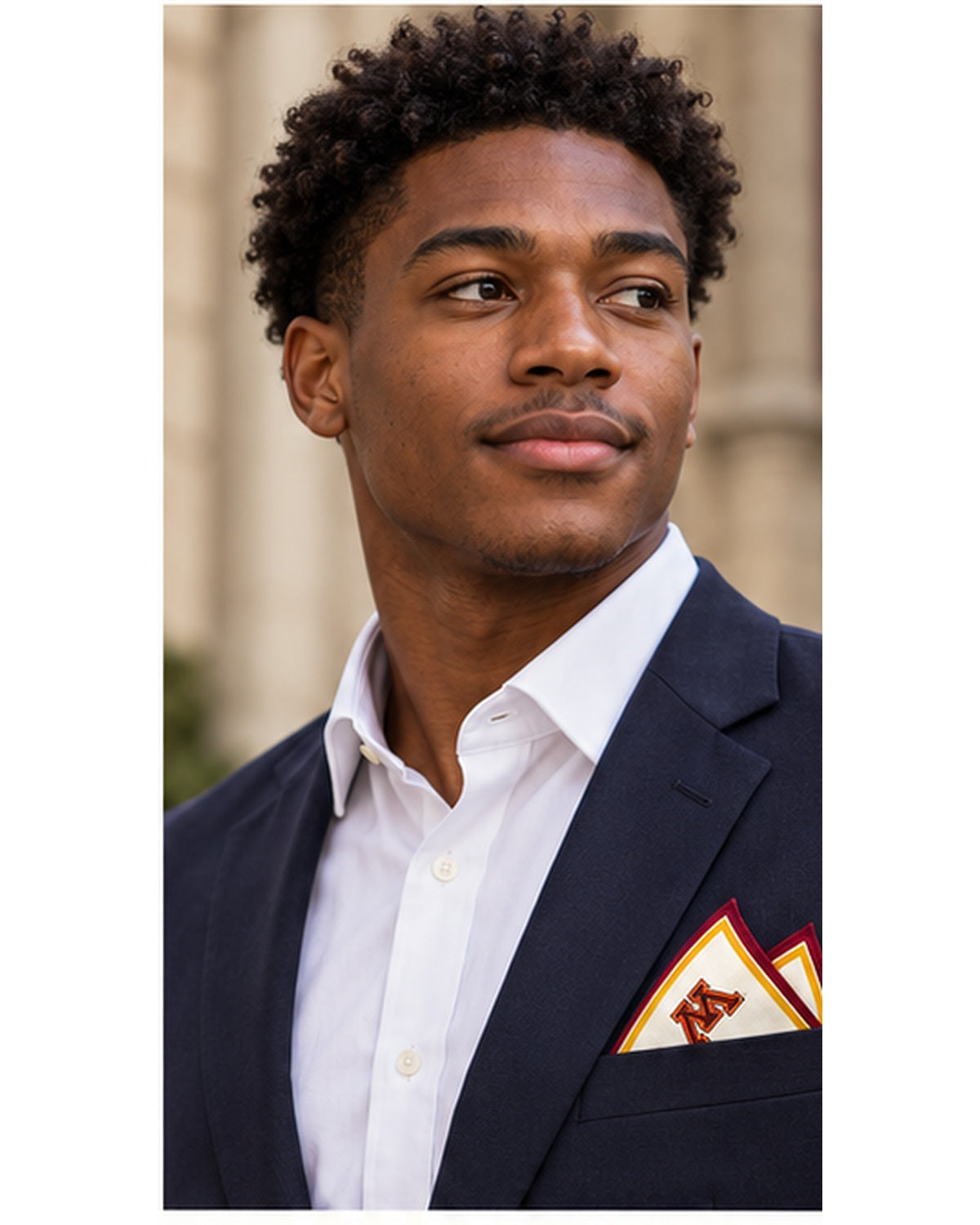 Male model in a navy blazer wearing the Honey Pocket ivory silk pocket square with maroon and gold borders and the University of Minnesota M