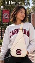 Model wearing the ivory University of South Carolina Honey Sling crossbody on campus