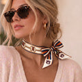 Blonde model wearing the b.Honey Ribbon: Auburn University tied at the neck
