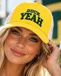 Female model wearing the Honey Lid yellow and white Richardson 115 low-profile trucker hat with green Duck Yeah embroidery for the University of Oregon