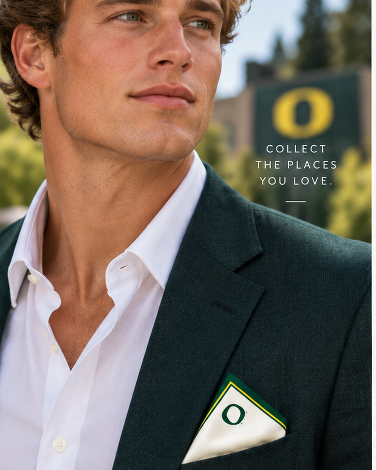 Male model in a green blazer wearing the Honey Pocket ivory silk pocket square with green and yellow borders and the University of Oregon O