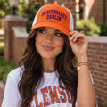 Woman wearing the orange b.Honey Lid: Clemson University with Death Valley Darlin' embroidery