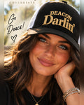 Female model wearing the black and white Honey Lid trucker hat with old gold Deacon Darlin' embroidery for Wake Forest University